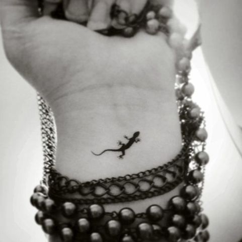 Super tiny lizard tattoo on the wrist